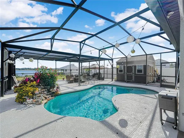 a view of a patio with table and chairs under an umbrella