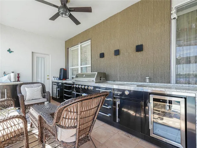 a bathroom with a granite countertop toilet a sink and a mirror
