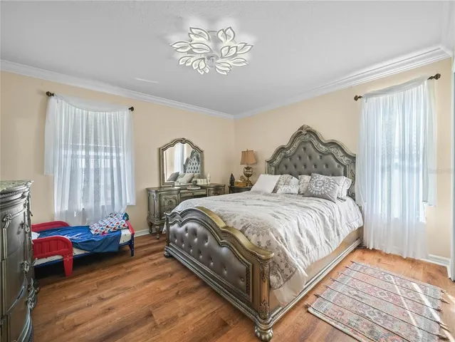 a bedroom with a bed and a chandelier
