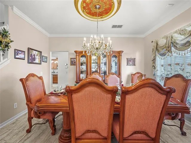 a view of a dining room with furniture and chandelier