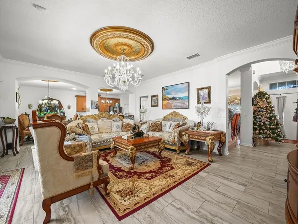 a living room with furniture a fireplace and a large window