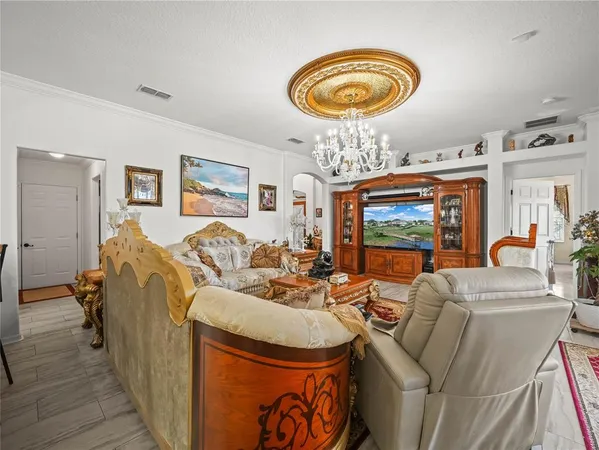 a view of a dining room with furniture and chandelier