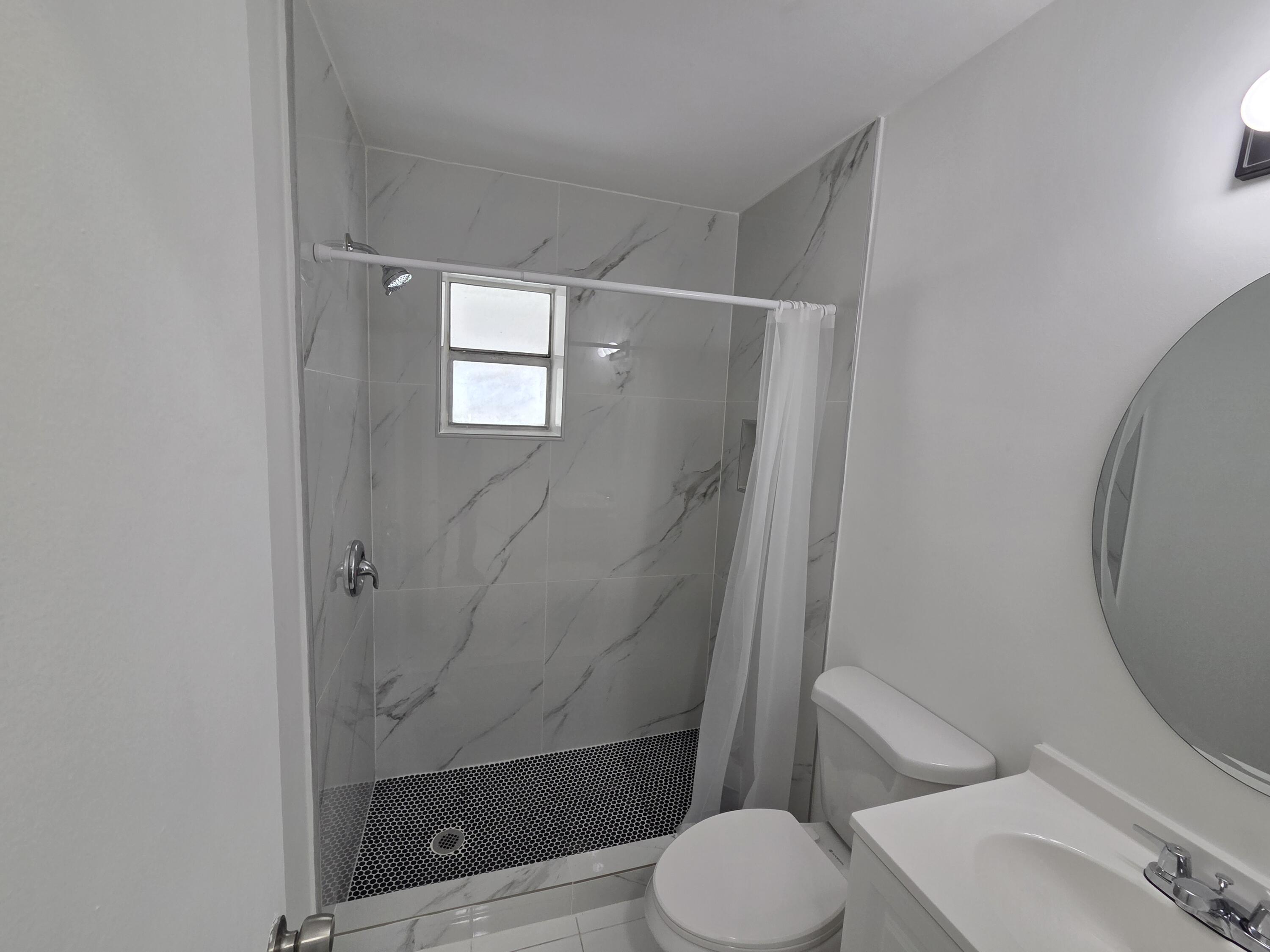 2847 Duke Lane Delray Beach, FL 33445 - Photo 11 of 17 a bathroom with a toilet and a shower