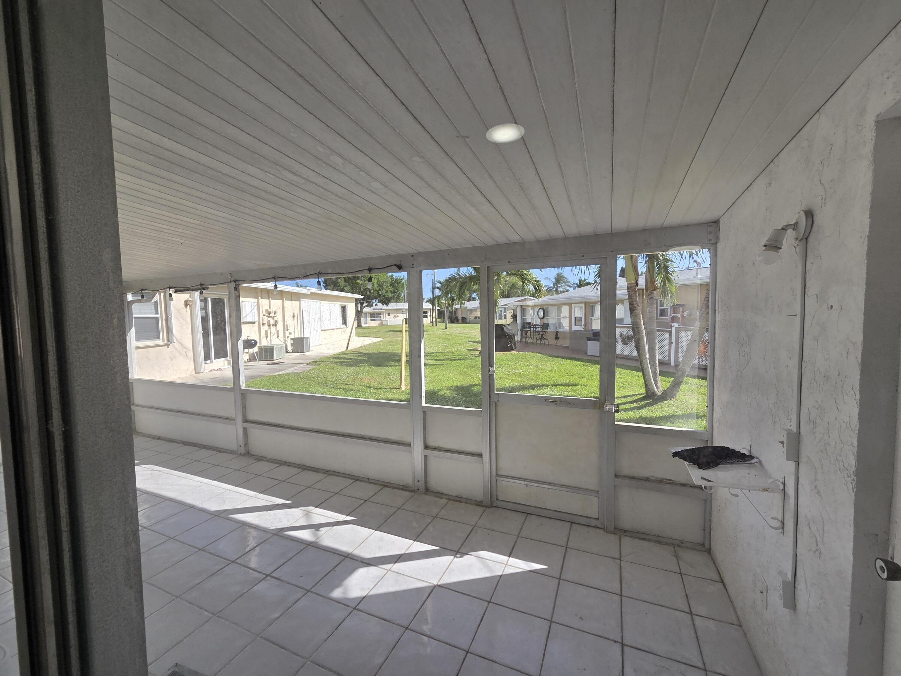2847 Duke Lane Delray Beach, FL 33445 - Photo 13 of 17 a view of a porch and garden