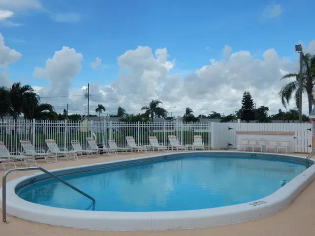 a swimming pool with outdoor seating and city view
