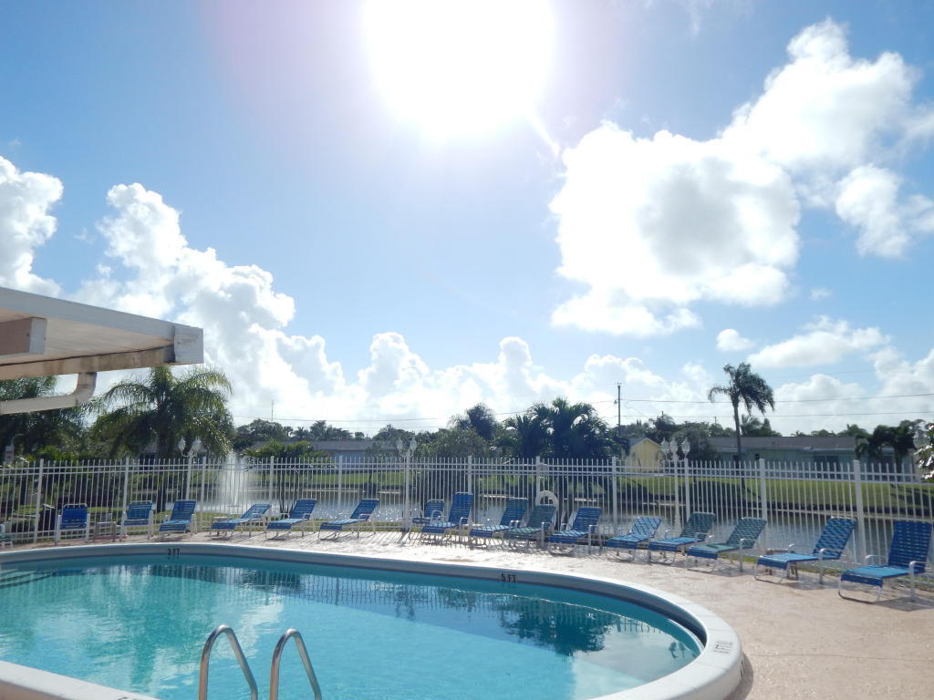 2847 Duke Lane Delray Beach, FL 33445 - Photo 16 of 17 a swimming pool with outdoor seating and city view