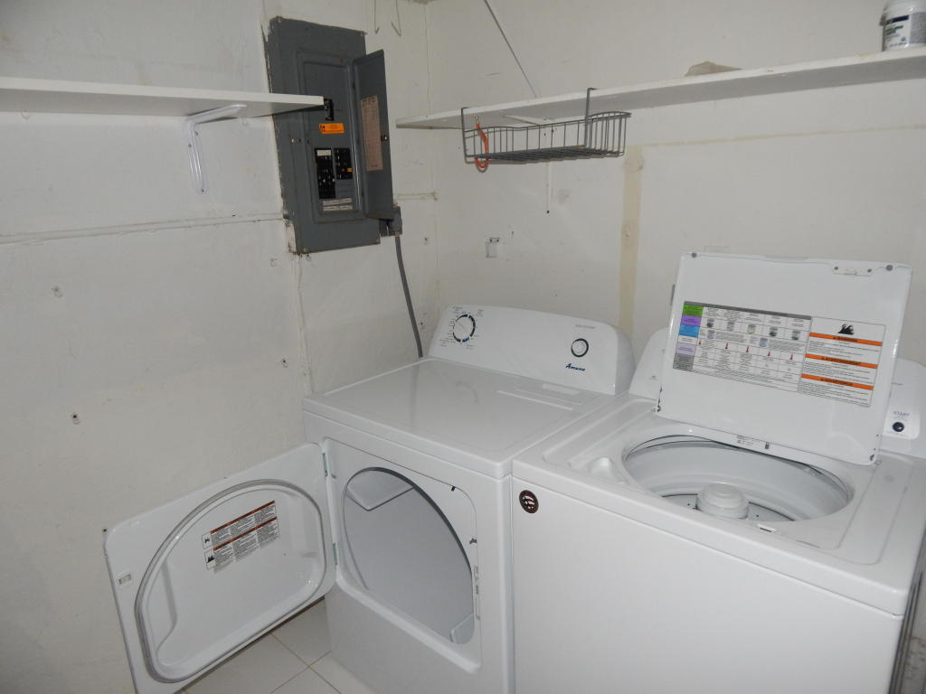 2847 Duke Lane Delray Beach, FL 33445 - Photo 17 of 17 a bathroom with a sink and washing machine