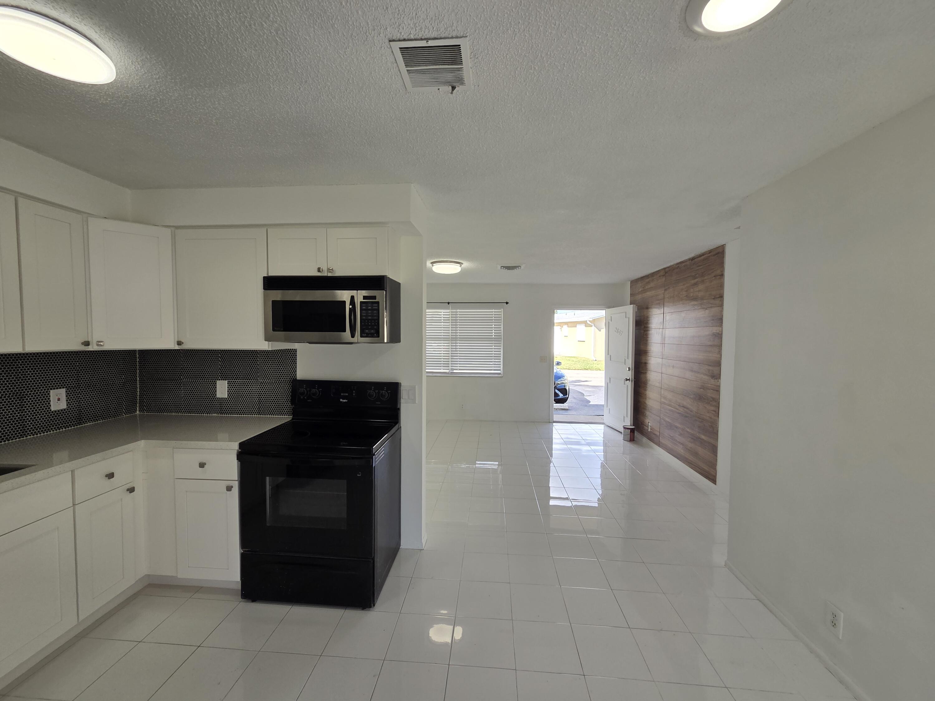 2847 Duke Lane Delray Beach, FL 33445 - Photo 8 of 17 a kitchen with a sink and cabinets