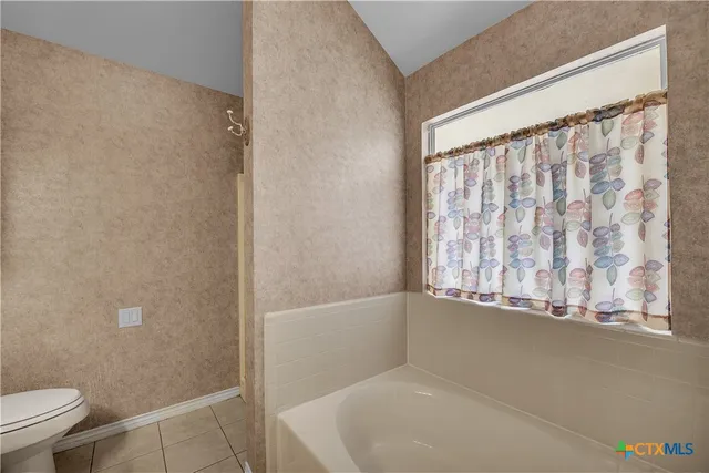 a view of bathroom with bathtub and shower