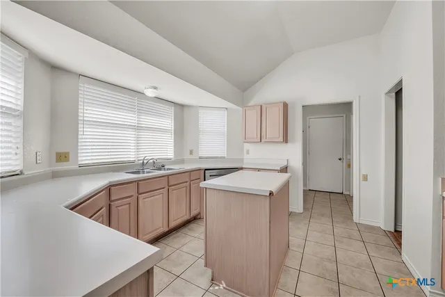 a kitchen that has a sink and a stove in it