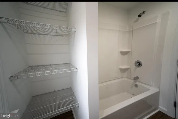 a bathroom with a sink toilet and window