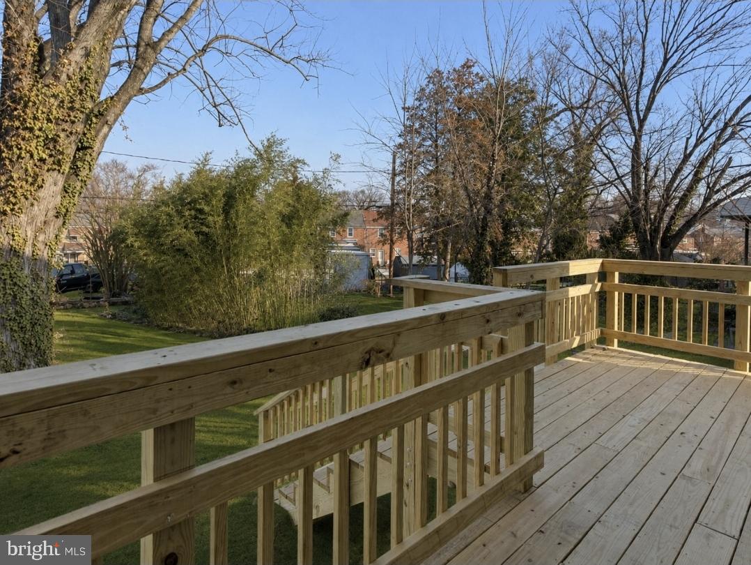 5102 Plymouth Road Baltimore, MD 21214 - Photo 27 of 32 a balcony with wooden floor and yard