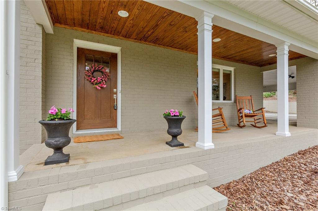 831 Trollinger Road Asheboro, NC 27203 - Photo 4 of 50 Rocking chair front porch with recessed lights and plank ceiling
