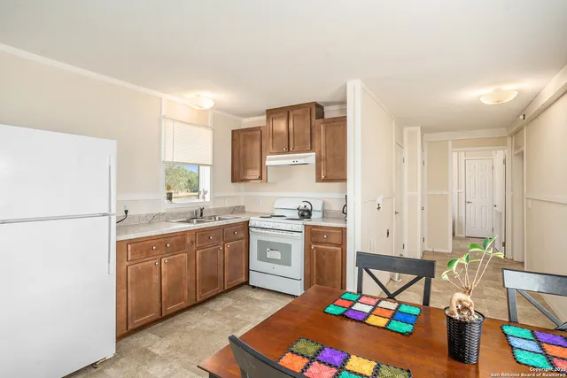 a kitchen with a sink stove and white cabinets