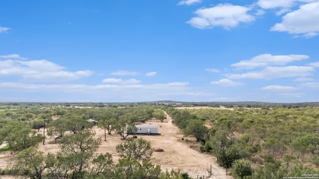 an aerial view of residential houses with outdoor space
