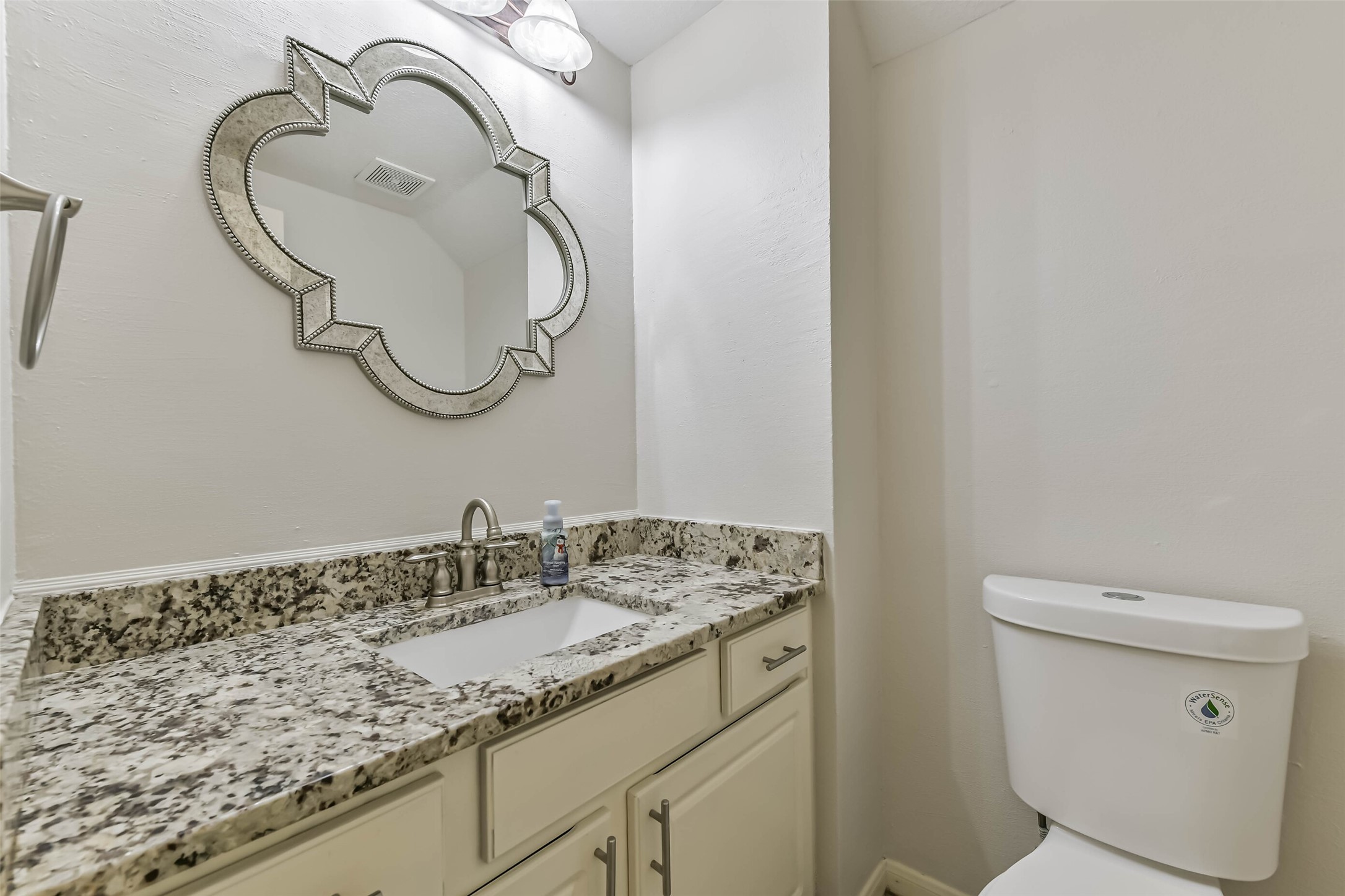 6338 Maple Spring Place Humble, TX 77346 - Photo 24 of 50 A welcoming finishing touch for visiting guests, this powder room pairs a decorative mirror with a spacious vanity. Cabinet and drawer storage keep essentials tucked away, leaving the countertop ready for a few thoughtful accents.