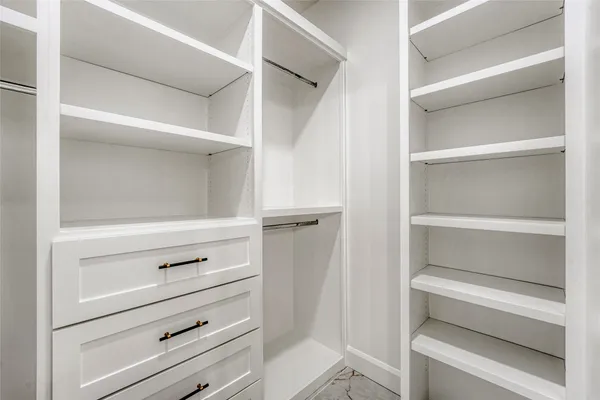 a kitchen with a sink a counter space and wooden floor