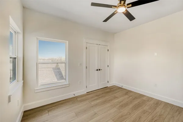 a view of hallway with wooden floor