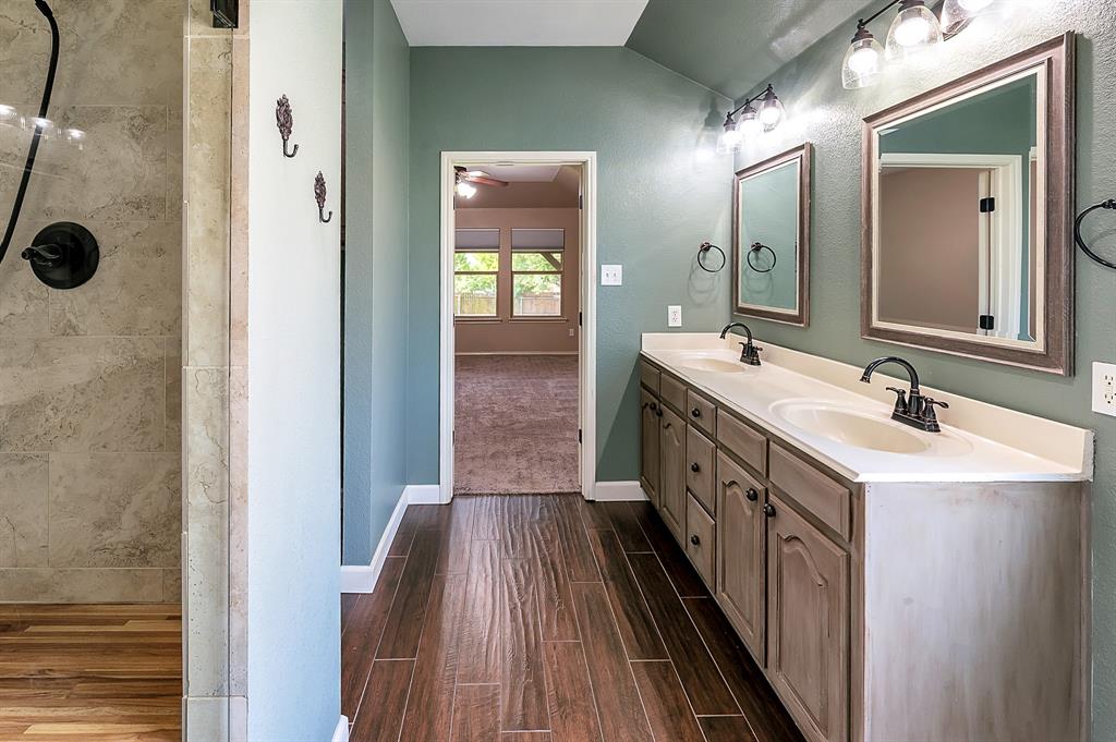 1070 Shepard Lane Lavon, TX 75166 - Photo 19 of 29 a spacious bathroom with a double vanity sink a mirror and shower
