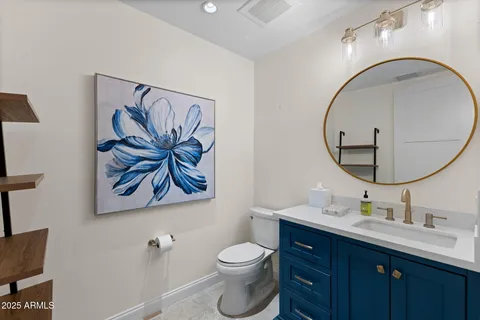 a bathroom with a toilet a sink and mirror