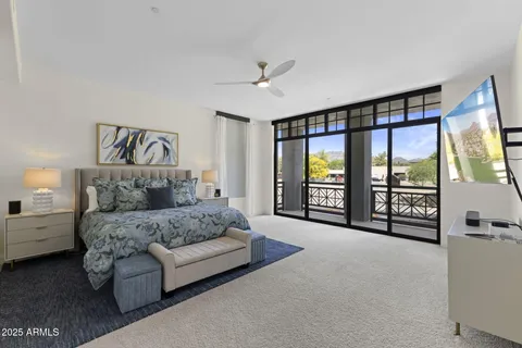 a spacious bedroom with a large bed and a large window