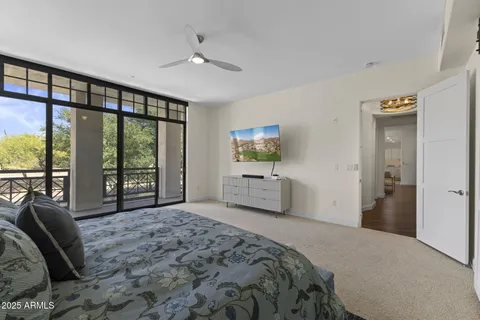 a spacious bedroom with a large bed and a large window