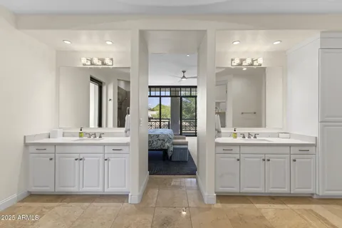 a spacious bathroom with a granite countertop sink a toilet mirror and a bathtub