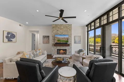 a living room with fireplace furniture and a flat screen tv