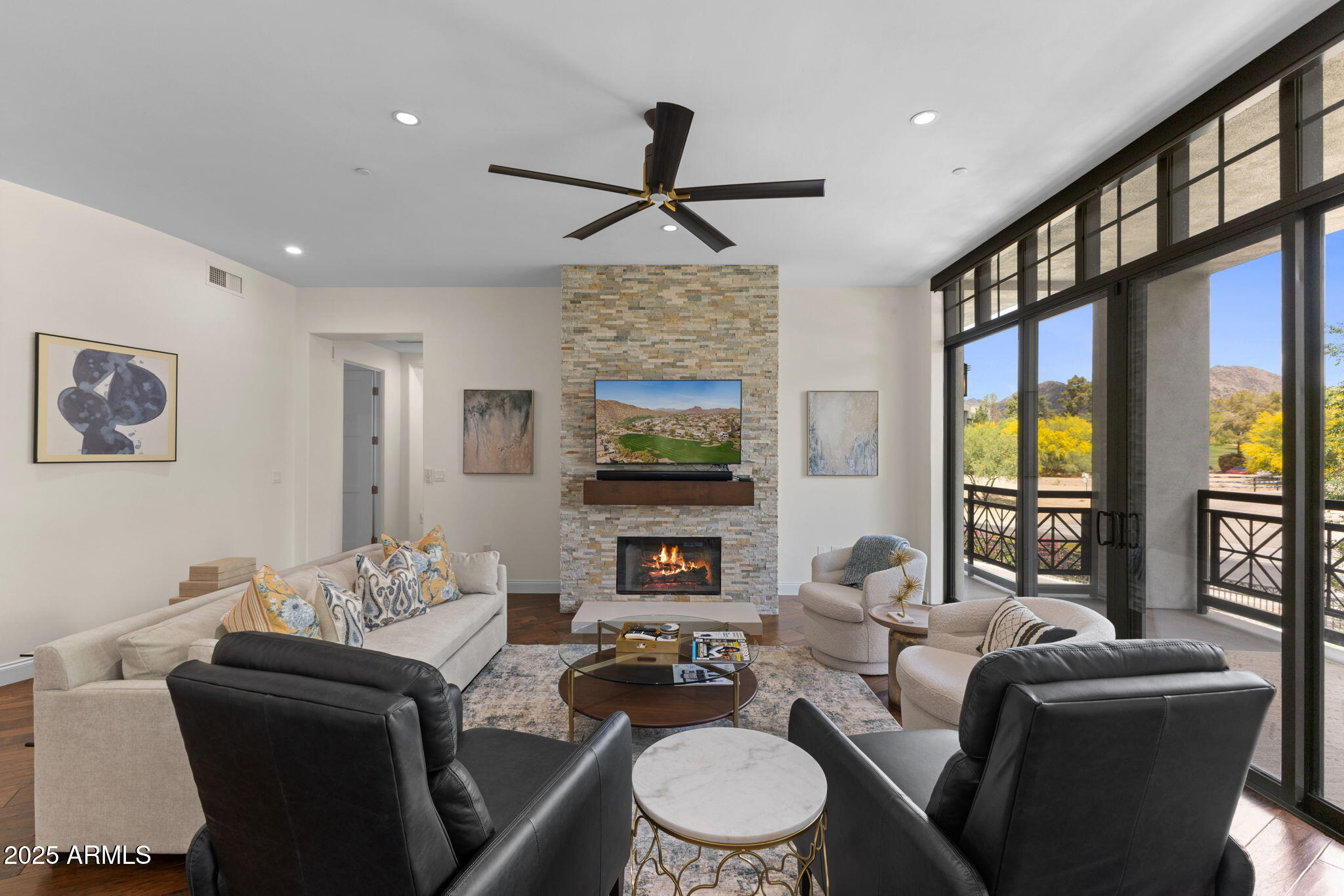 8 Biltmore Estate, Unit 215 Phoenix, AZ 85016 - Photo 3 of 26 a living room with fireplace furniture and a flat screen tv