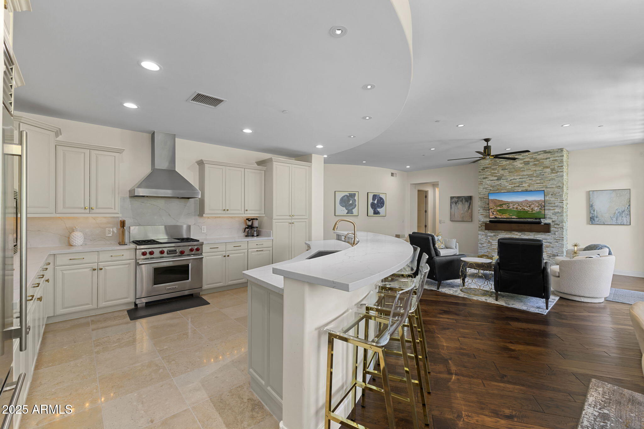 8 Biltmore Estate, Unit 215 Phoenix, AZ 85016 - Photo 9 of 26 a kitchen with stainless steel appliances granite countertop a stove top oven a sink dishwasher a dining table and chairs with wooden floor