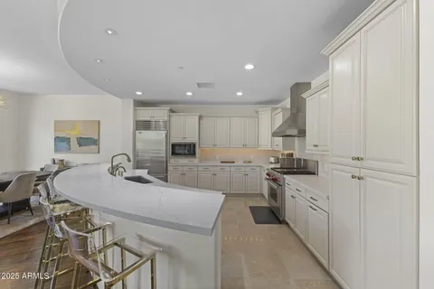 a kitchen with stainless steel appliances kitchen island granite countertop a sink and cabinets