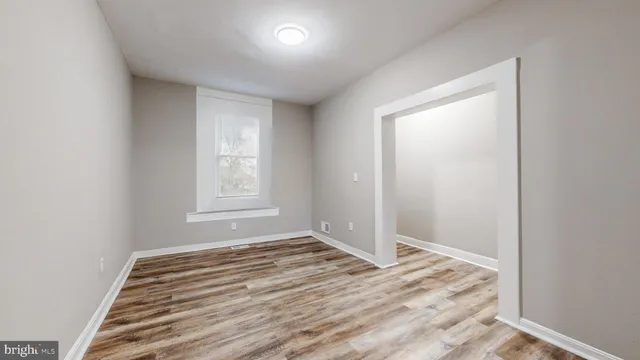 a view of a room with wooden floor and window