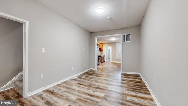 a view of a hallway with wooden floor