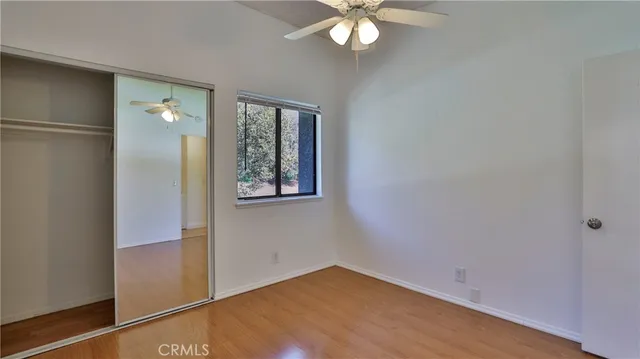 an empty room with chandelier fan