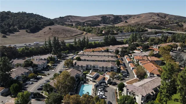 an aerial view of a residential apartment building with a yard