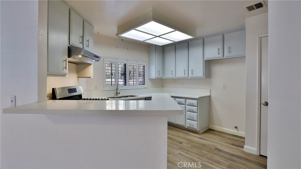 26 Willowcrest Lane Phillips Ranch, CA 91766 - Photo 8 of 39 a kitchen with stainless steel appliances granite countertop a sink a stove and a refrigerator