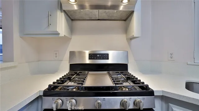 a stove top oven sitting inside of a kitchen