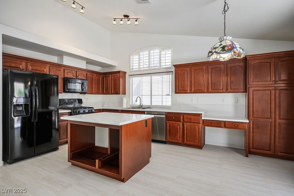1812 Jack Rabbit Way Las Vegas, NV 89128 - Photo 13 of 44 Kitchen with black appliances, hanging light fixtures, a center island, light tile patterned flooring, and open shelves