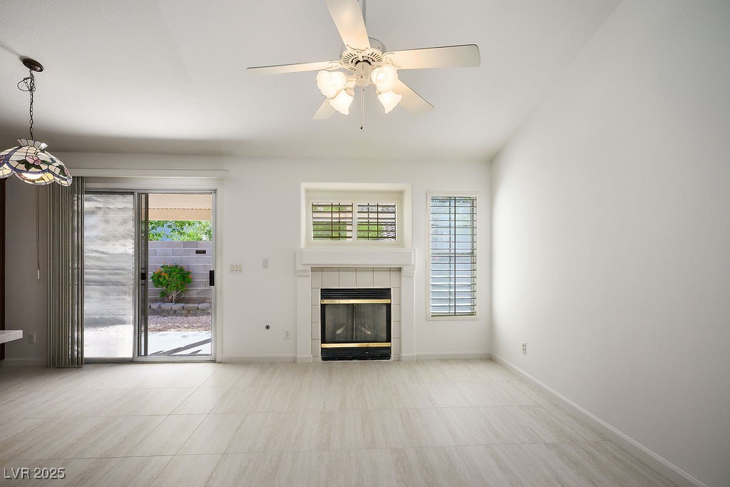 1812 Jack Rabbit Way Las Vegas, NV 89128 - Photo 18 of 44 Family room with a tile fireplace and ceiling fan