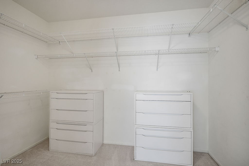 1812 Jack Rabbit Way Las Vegas, NV 89128 - Photo 31 of 44 Master's bedroom spacious closet with light colored carpet