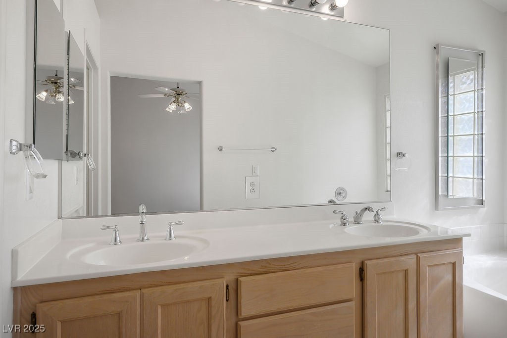 1812 Jack Rabbit Way Las Vegas, NV 89128 - Photo 32 of 44 Bathroom featuring double vanity and a jetted bathtub