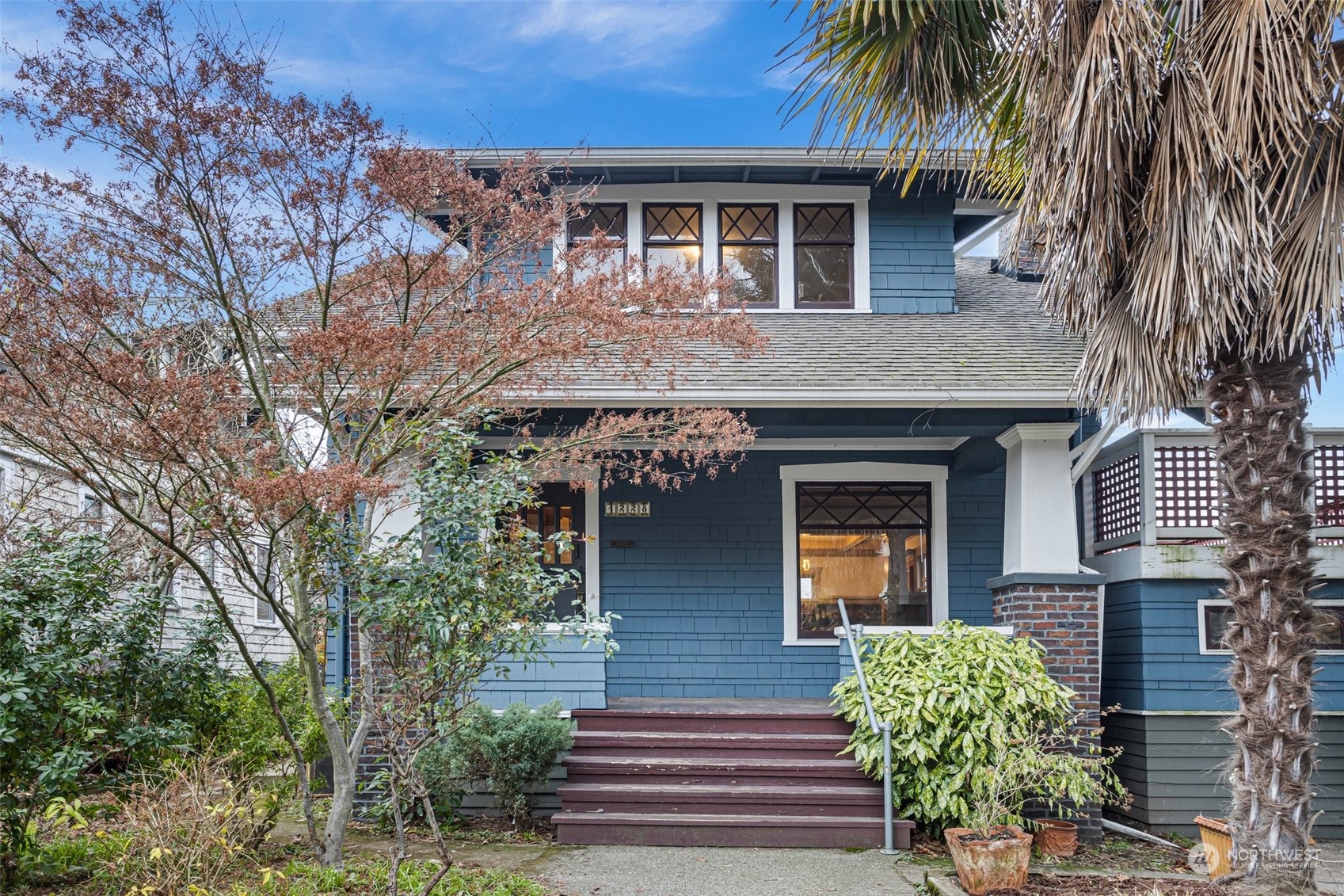 a front view of a house with plants