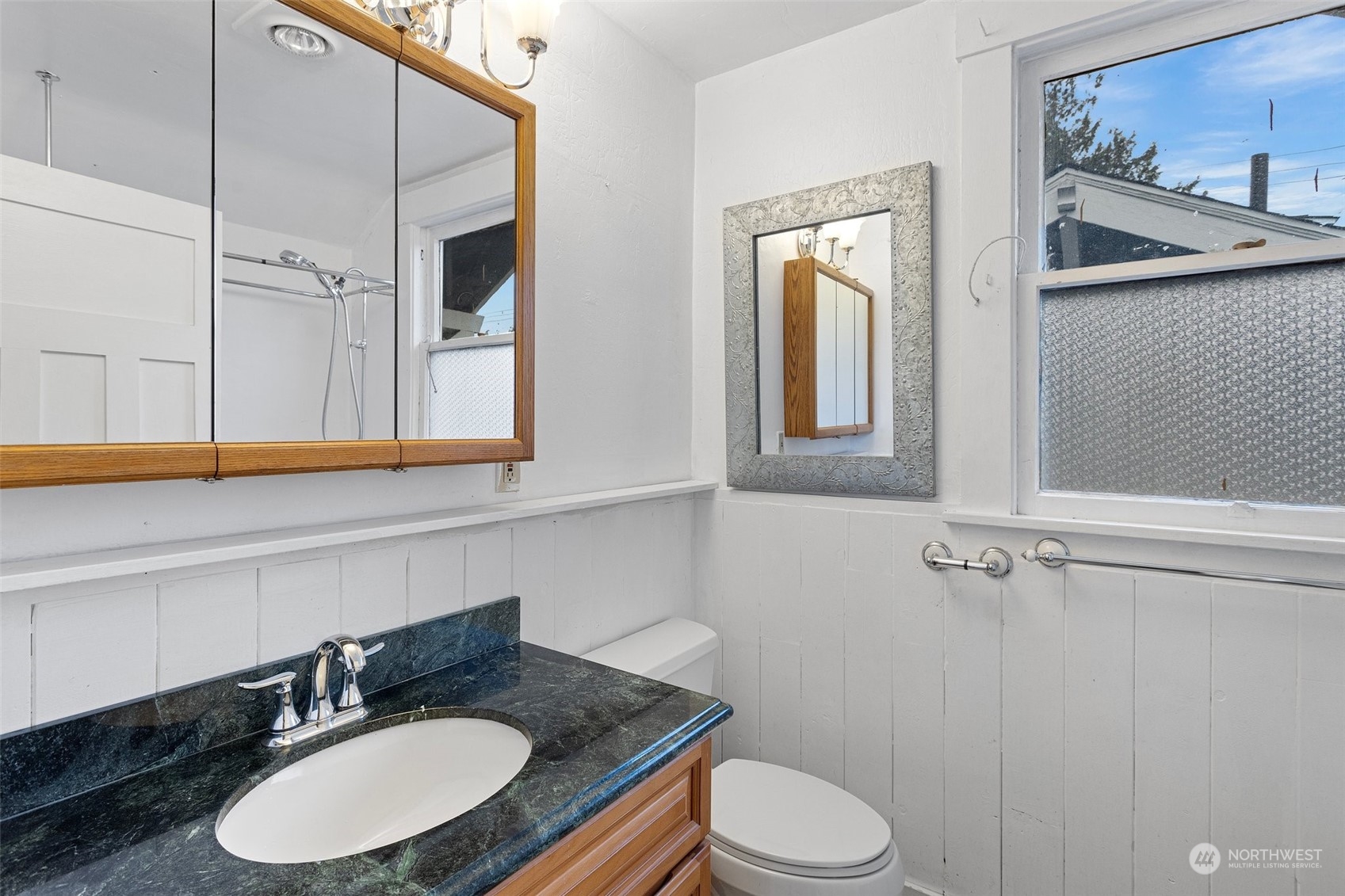 4228 Eastern Avenue North Seattle, WA 98103 - Photo 15 of 27 a bathroom with a granite countertop sink and a mirror