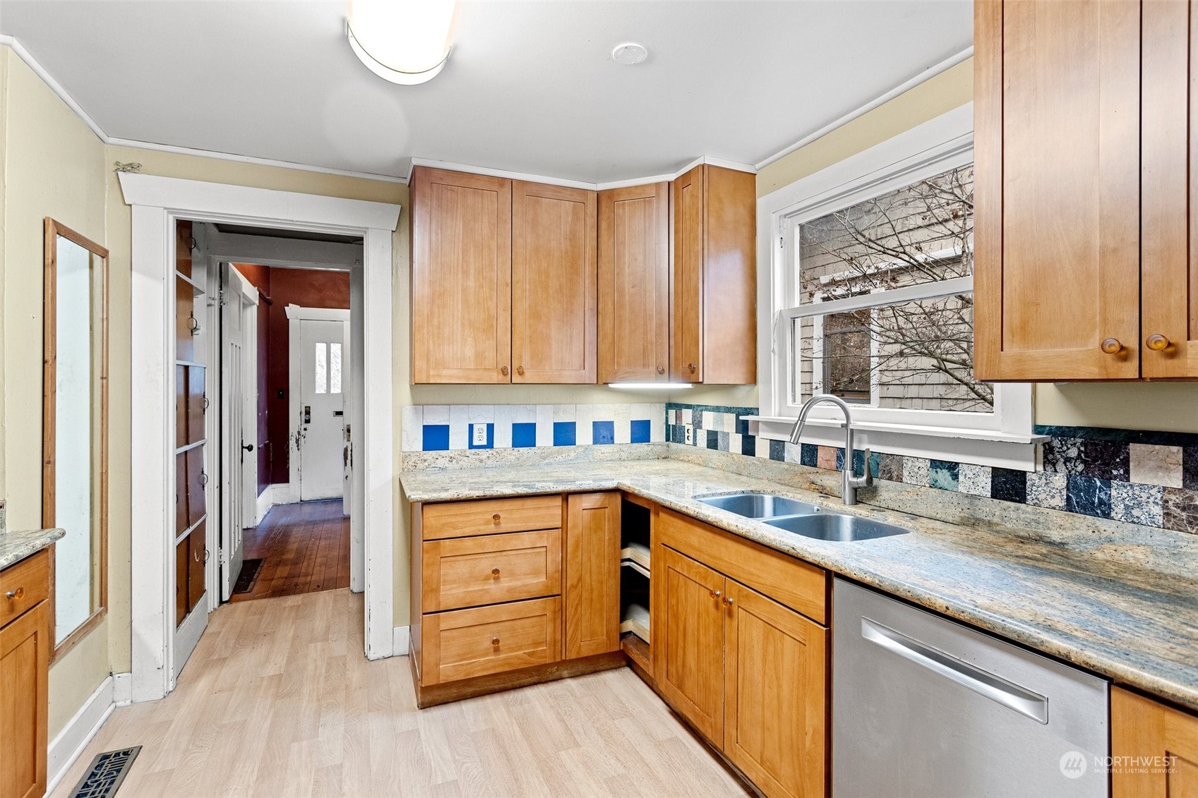4228 Eastern Avenue North Seattle, WA 98103 - Photo 9 of 27 a kitchen with stainless steel appliances granite countertop a sink dishwasher stove and cabinets with wooden floor