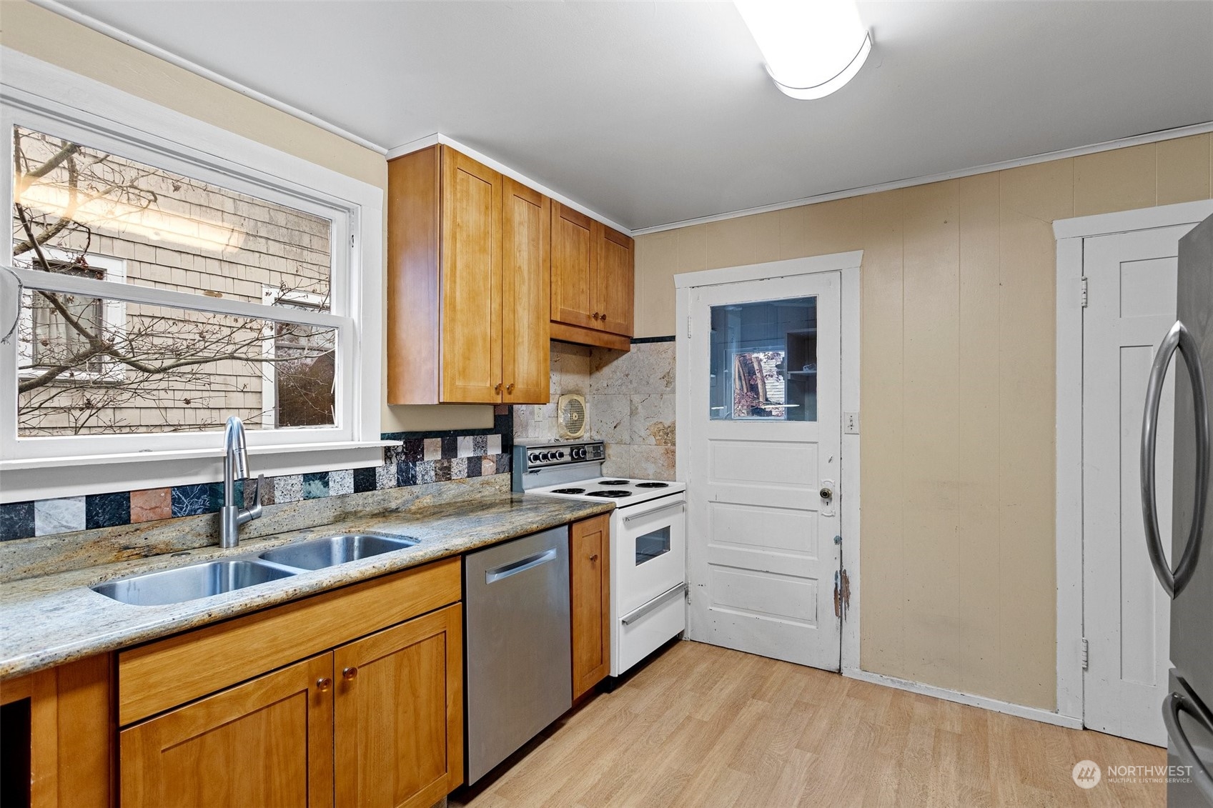 4228 Eastern Avenue North Seattle, WA 98103 - Photo 10 of 27 a kitchen with a sink cabinets stainless steel appliances and a window