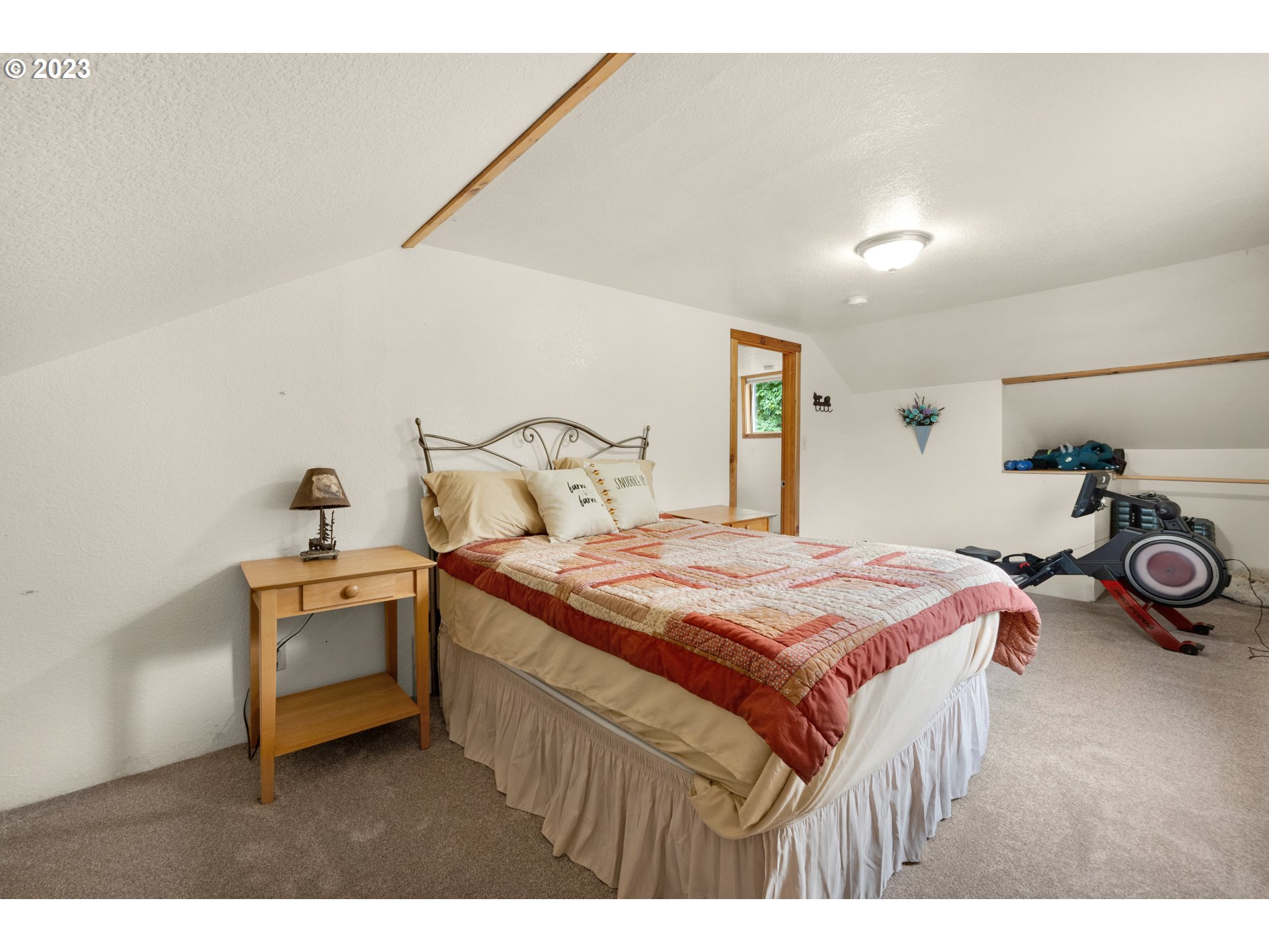 92357 Maki Road Astoria, OR 97103 - Photo 22 of 41 a bedroom with a bed and a car