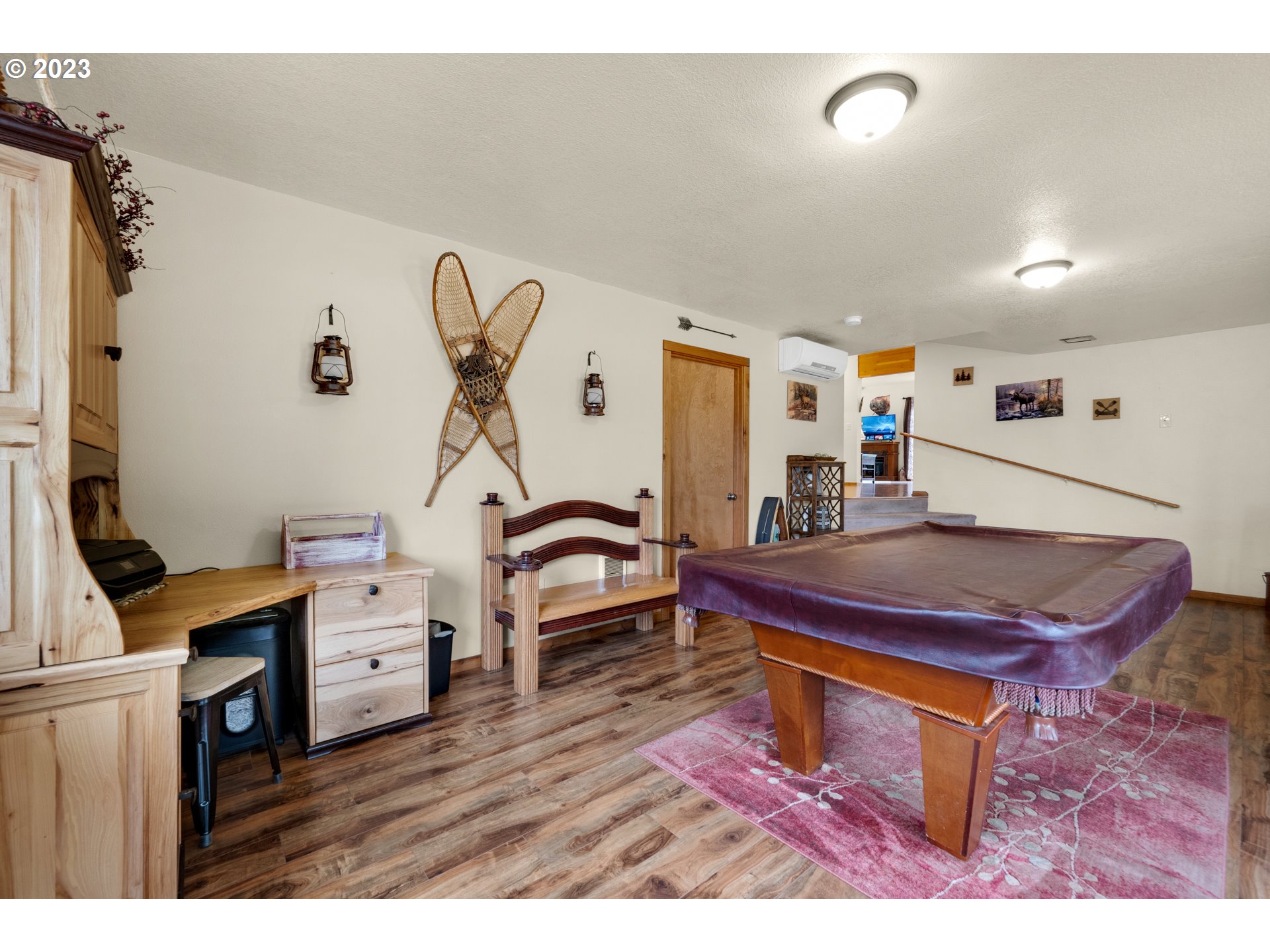 92357 Maki Road Astoria, OR 97103 - Photo 27 of 41 a living room with furniture a flat screen tv and gym equipment