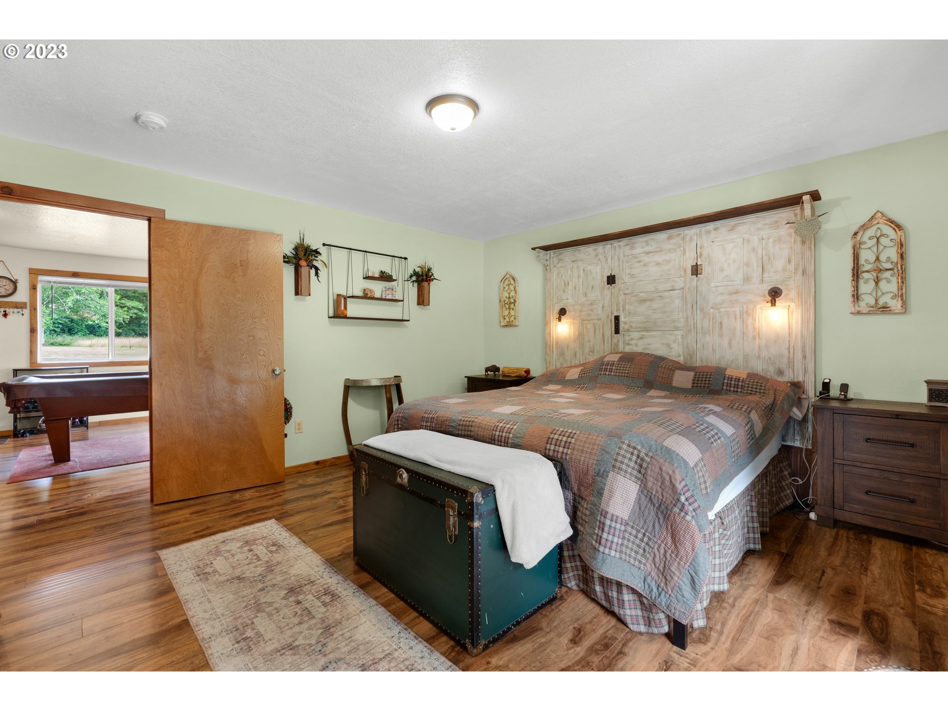 92357 Maki Road Astoria, OR 97103 - Photo 28 of 41 a bedroom with a bed and a view of living room