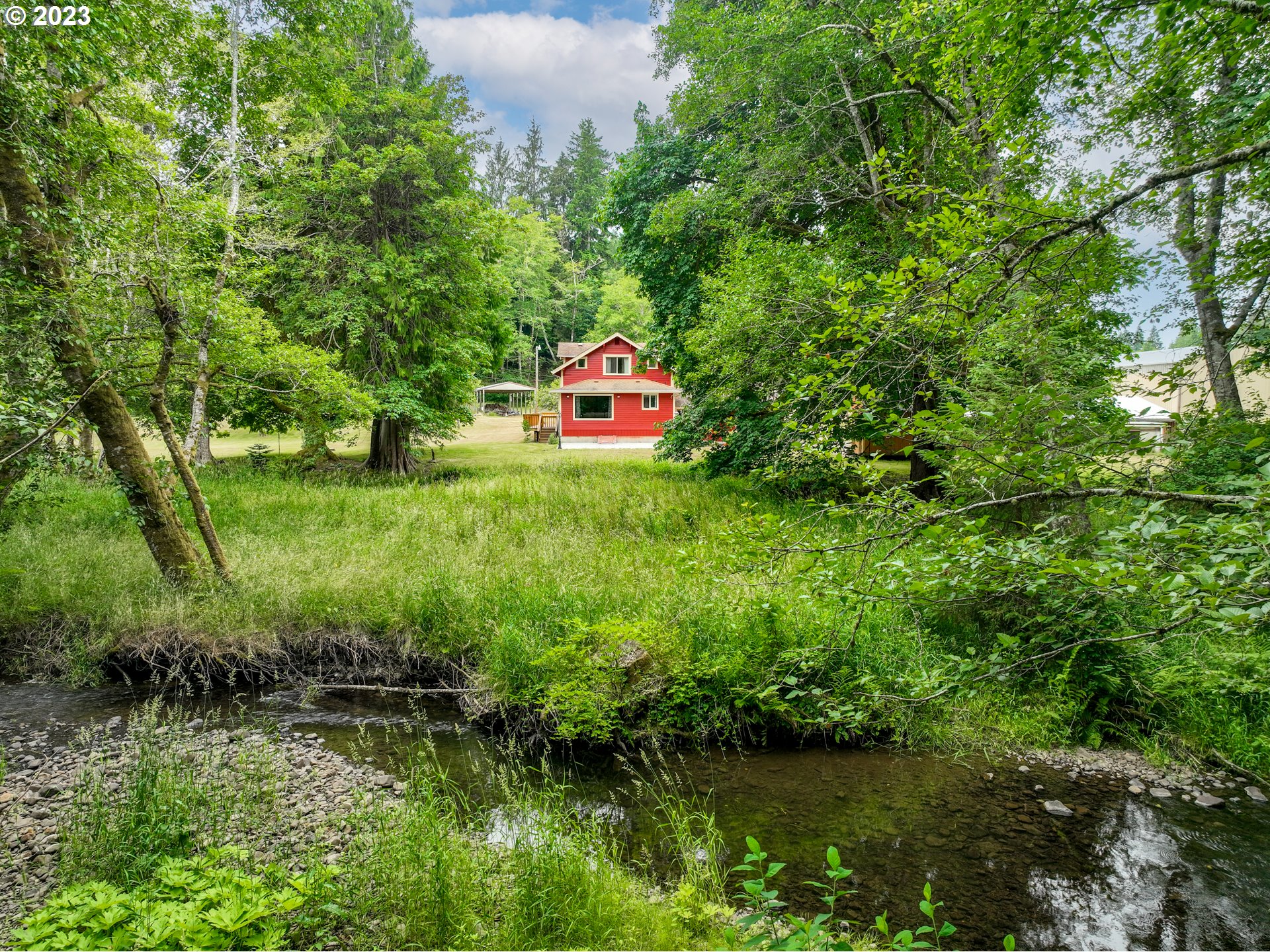 92357 Maki Road Astoria, OR 97103 - Photo 36 of 41 a backyard of a house with a yard and lake view