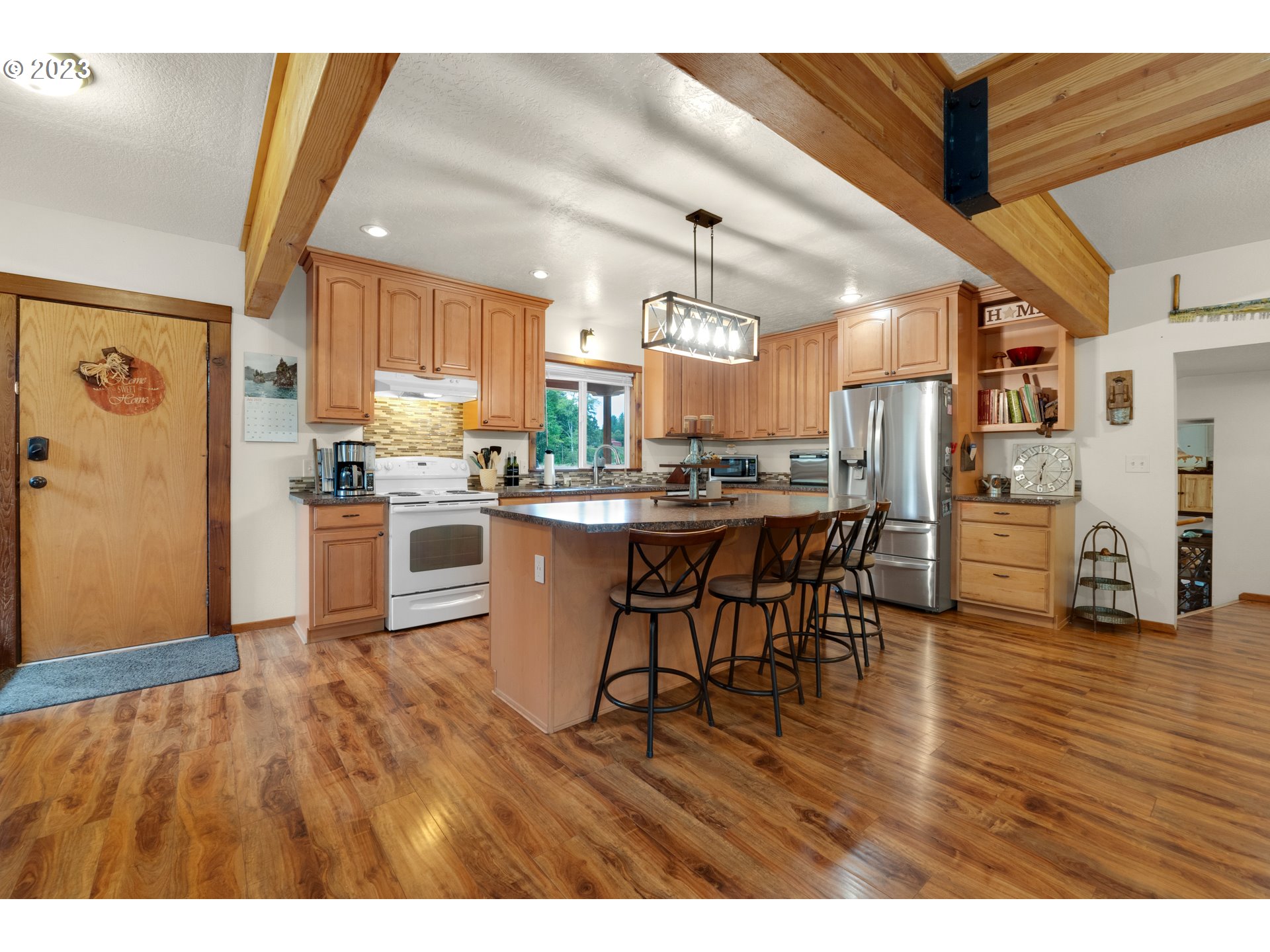 92357 Maki Road Astoria, OR 97103 - Photo 10 of 41 a kitchen with stainless steel appliances wooden floors and wooden cabinets
